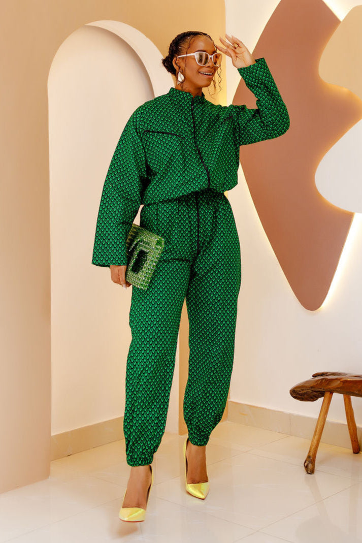 A model wearing the Oru Print Unisex Romper, featuring a relaxed fit, bold African-inspired print, and an adjustable waist for a stylish look.