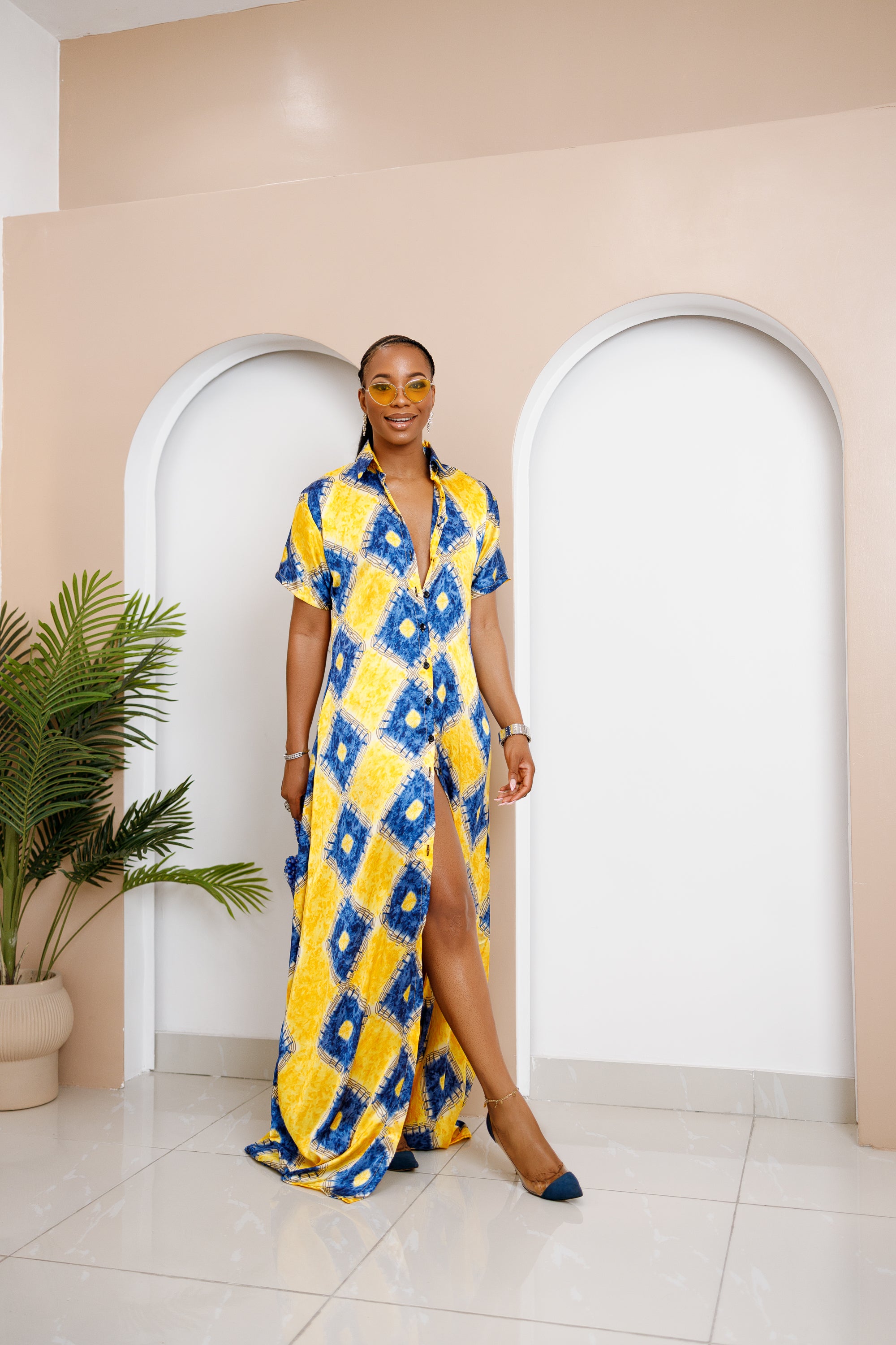 Sophisticated unlined kaftan dress made from traditional silk African Ankara fabric in vibrant multi-color patterns. Perfect for weddings, dinner parties, and formal events. Model height: 5'9".