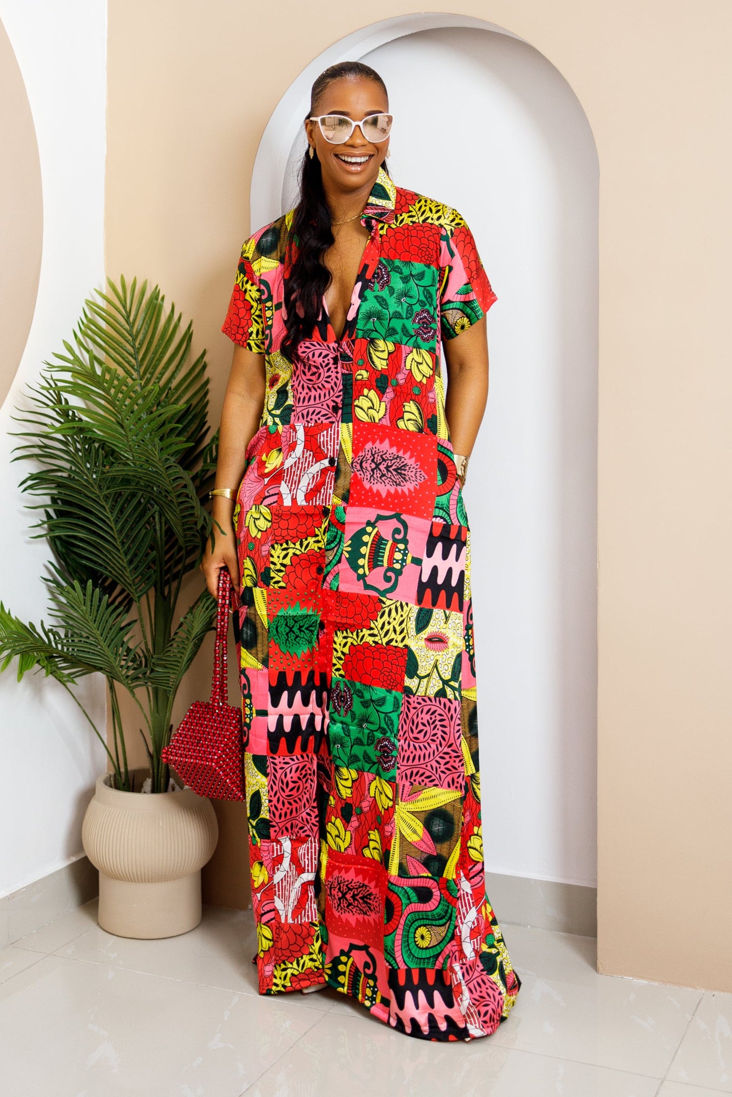 Sophisticated unlined kaftan dress made from traditional silk African Ankara fabric in vibrant multi-color patterns. Perfect for weddings, dinner parties, and formal events. Model height: 5'9".