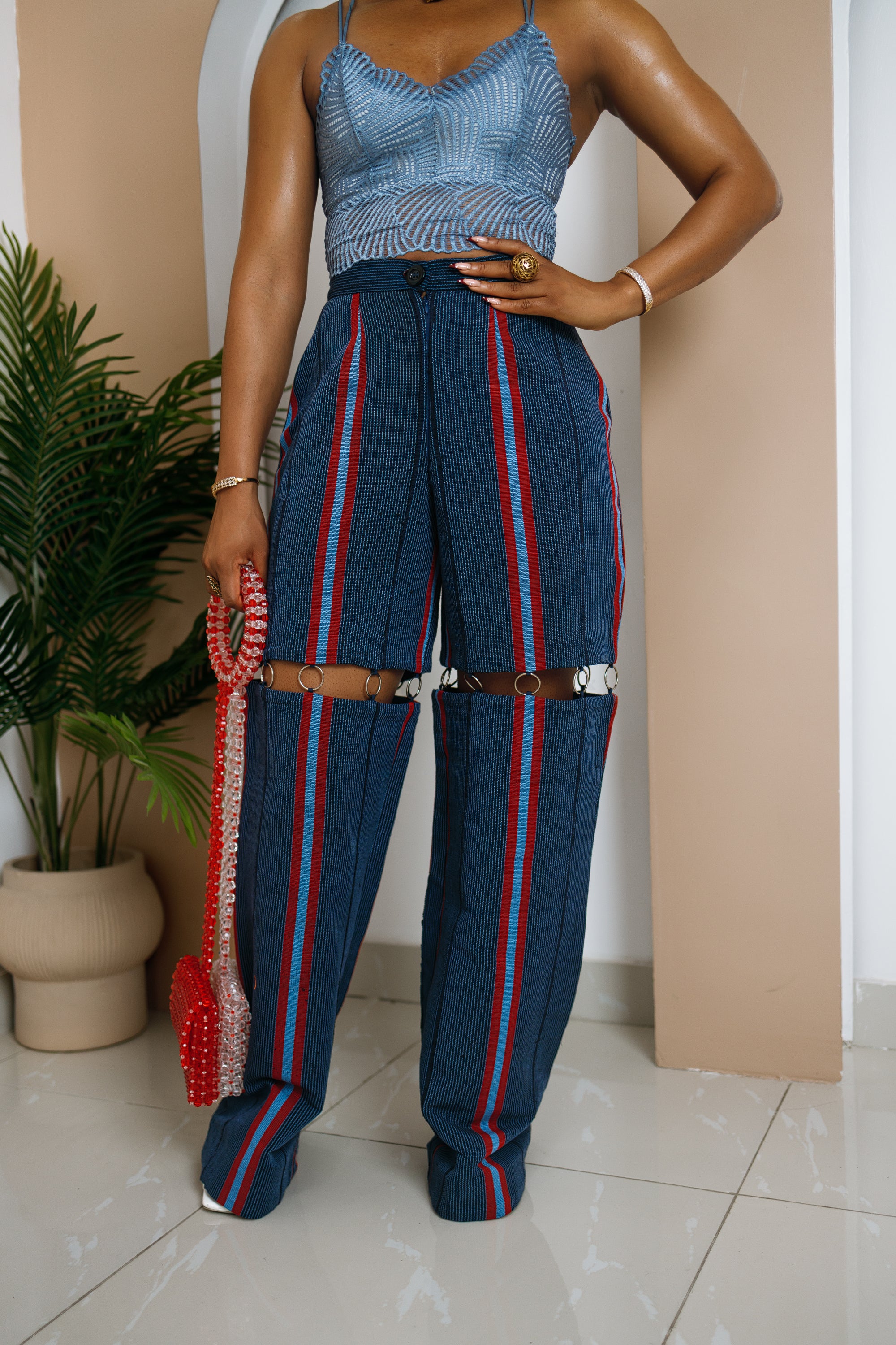 Chimezie Aso Oke pants in deep blue and red with ring details, handwoven traditional fabric crafted in Africa.
