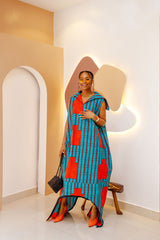 Model wearing a luxurious Cotton Ankara jumpsuit with a high neck, showcasing its multiple-wear functionality as a jumpsuit or dress.