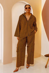 A stylish model wearing the Mkpari  Print Unisex Hoodie Co-ord Set, featuring a bold African-inspired print, relaxed-fit hoodie, and wide-leg pants.