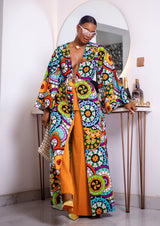 A woman posing in a multicolored African Print kimono.
