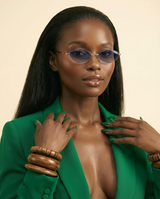 KAMMPT '25 Riviera Oval Sunglasses: Gradient Lens, Chic Alloy Glamour - chest-up portrait crop from mid-chest to just above the head, model facing camera, sunglasses are the PRIMARY FOCAL POINT and must be tack-sharp and clearly visible on the model's face, soft confident expression, shallow depth of field with sunglasses in razor-sharp focus