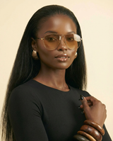 Chic Oversized Champagne Gradient Oval Sunglasses for Women - chest-up portrait crop from mid-chest to just above the head, model facing camera, sunglasses are the PRIMARY FOCAL POINT and must be tack-sharp and clearly visible on the model's face, soft confident expression, shallow depth of field with sunglasses in razor-sharp focus