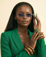 KAMMPT '25 Riviera Oval Sunglasses: Gradient Lens, Chic Alloy Glamour - chest-up portrait crop from mid-chest to just above the head, model facing camera, sunglasses are the PRIMARY FOCAL POINT and must be tack-sharp and clearly visible on the model's face, soft confident expression, shallow depth of field with sunglasses in razor-sharp focus